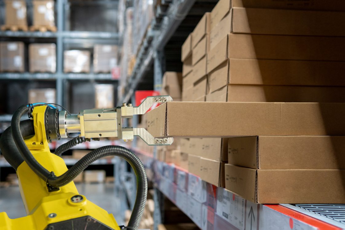 robot arm picking a box for an order from a Radial fulfillment center