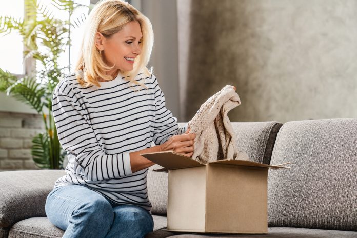 happy woman opening a package at home