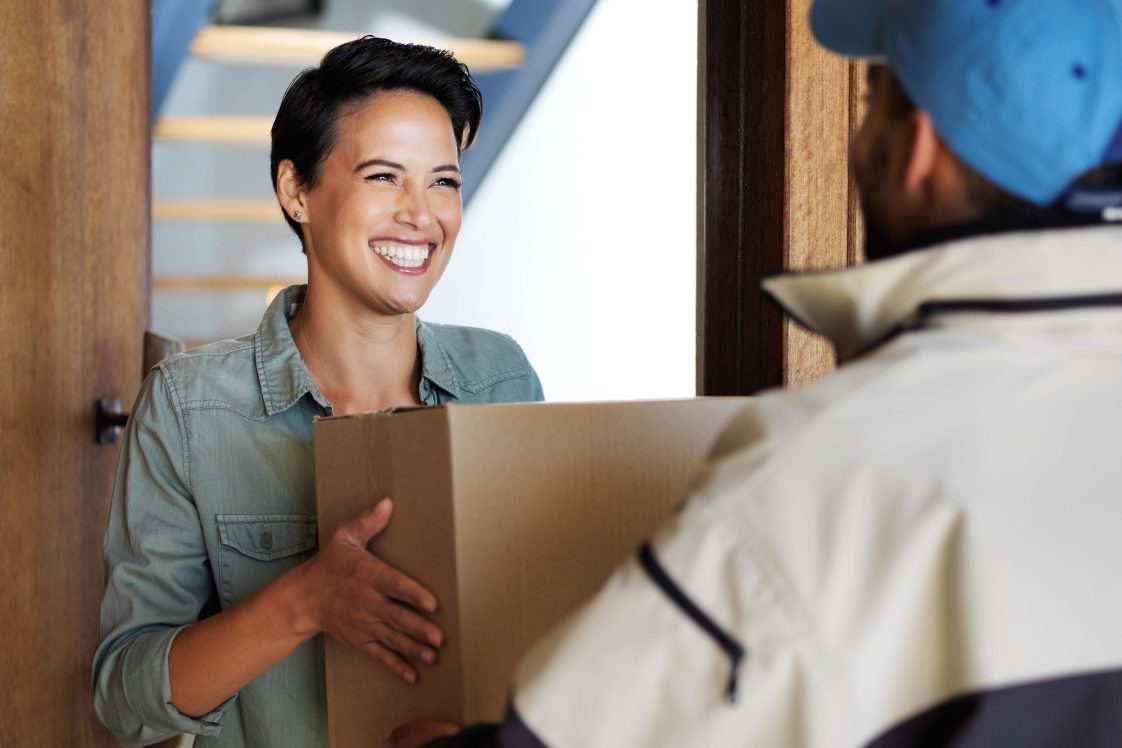 happy woman getting package at door