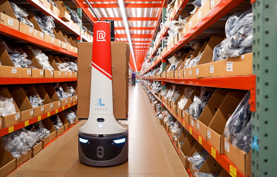 automated robot moving packages down the aisle in warehouse