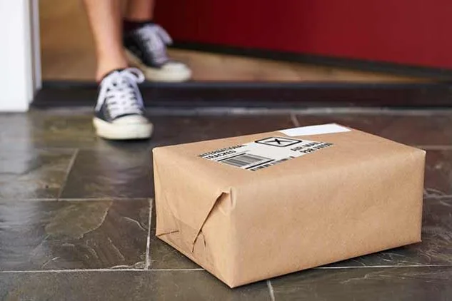 box on porch with person about to grab it