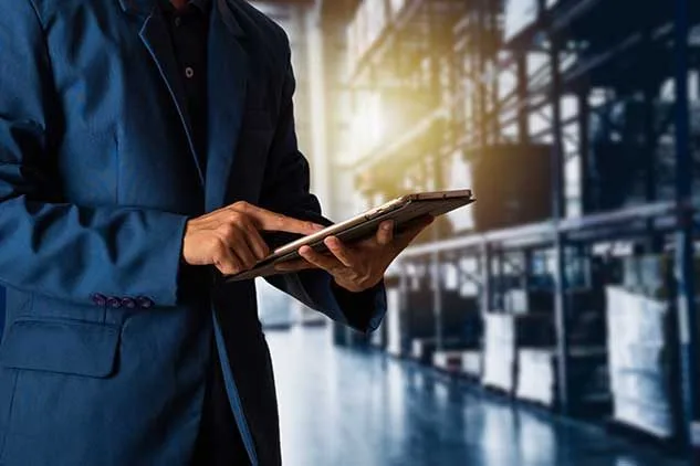 man looking at tablet in warehouse