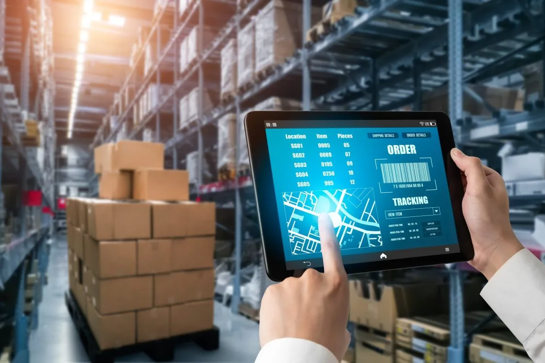 person working on a tablet in a warehouse