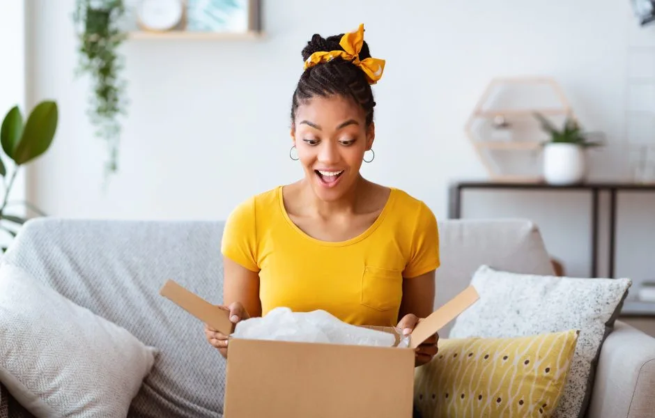 happy woman opening a package at home