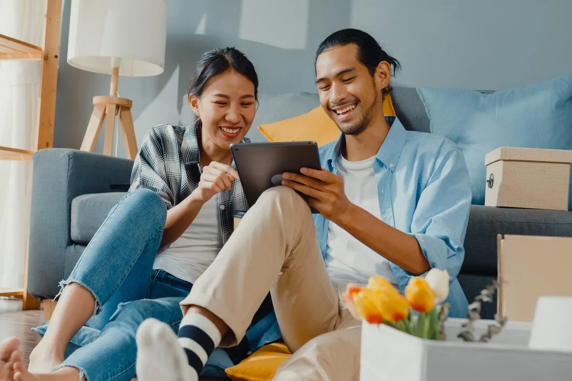 two people on phone looking at tablet