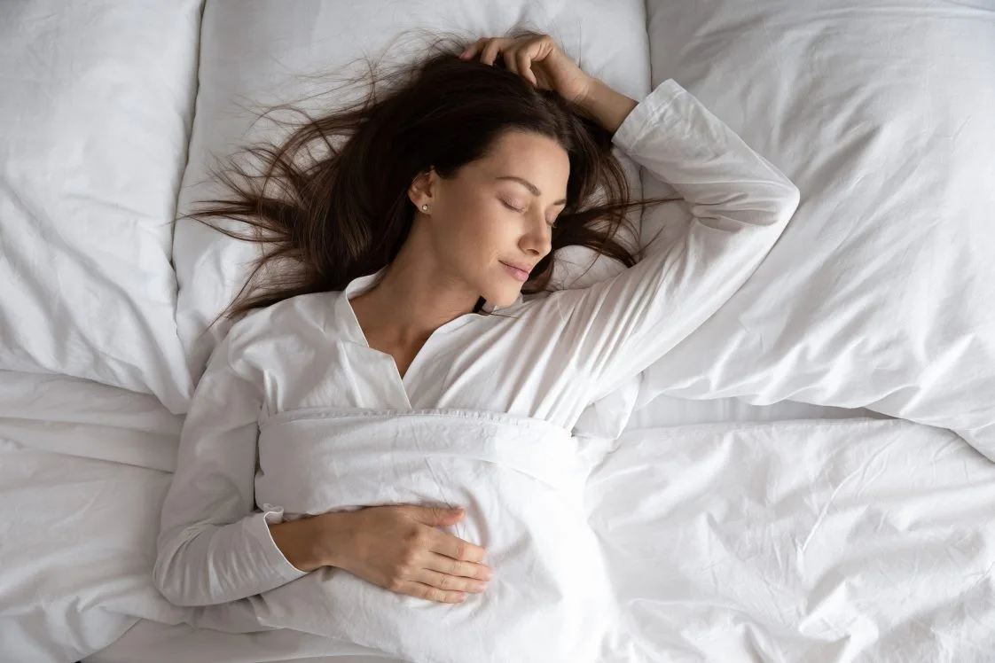 woman laying on bed relaxing