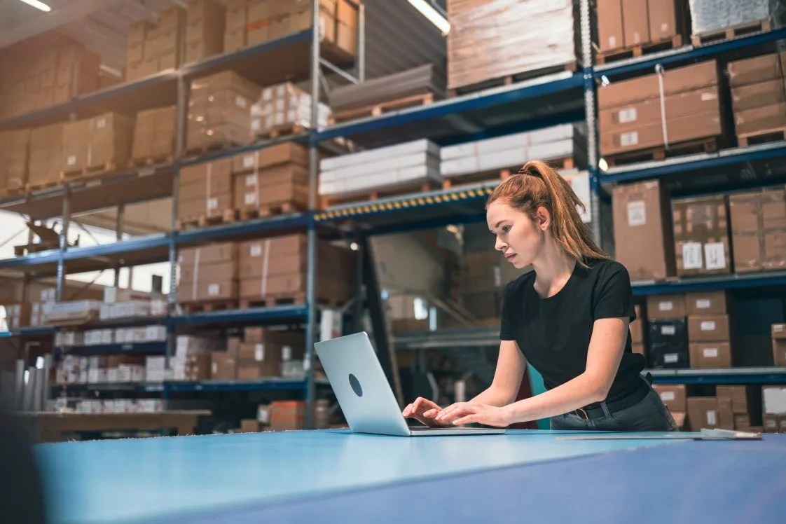 female working on computer in fulfillment center